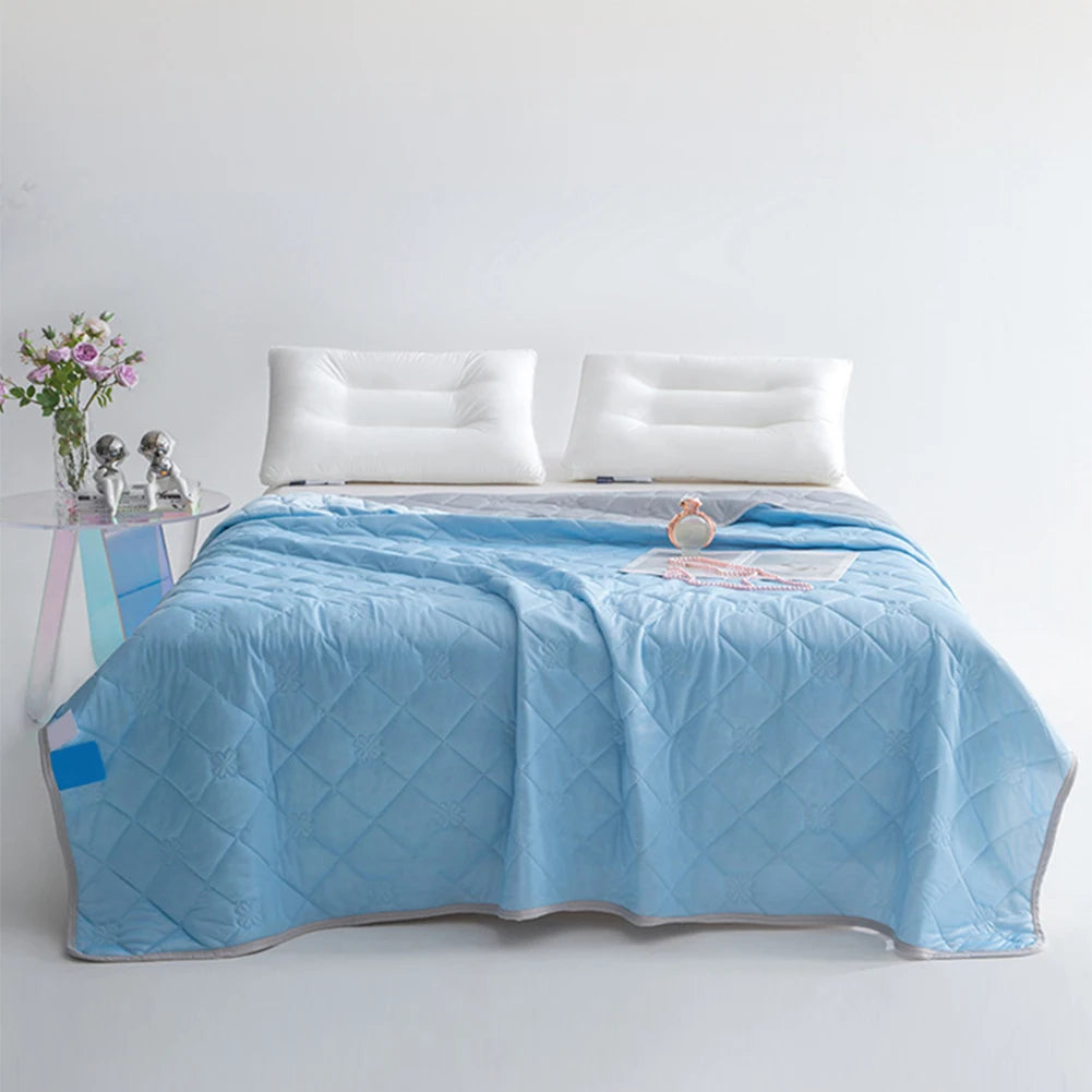 Cooling blanket folded on summer bedding