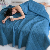 Person pulling the blanket lightly over legs