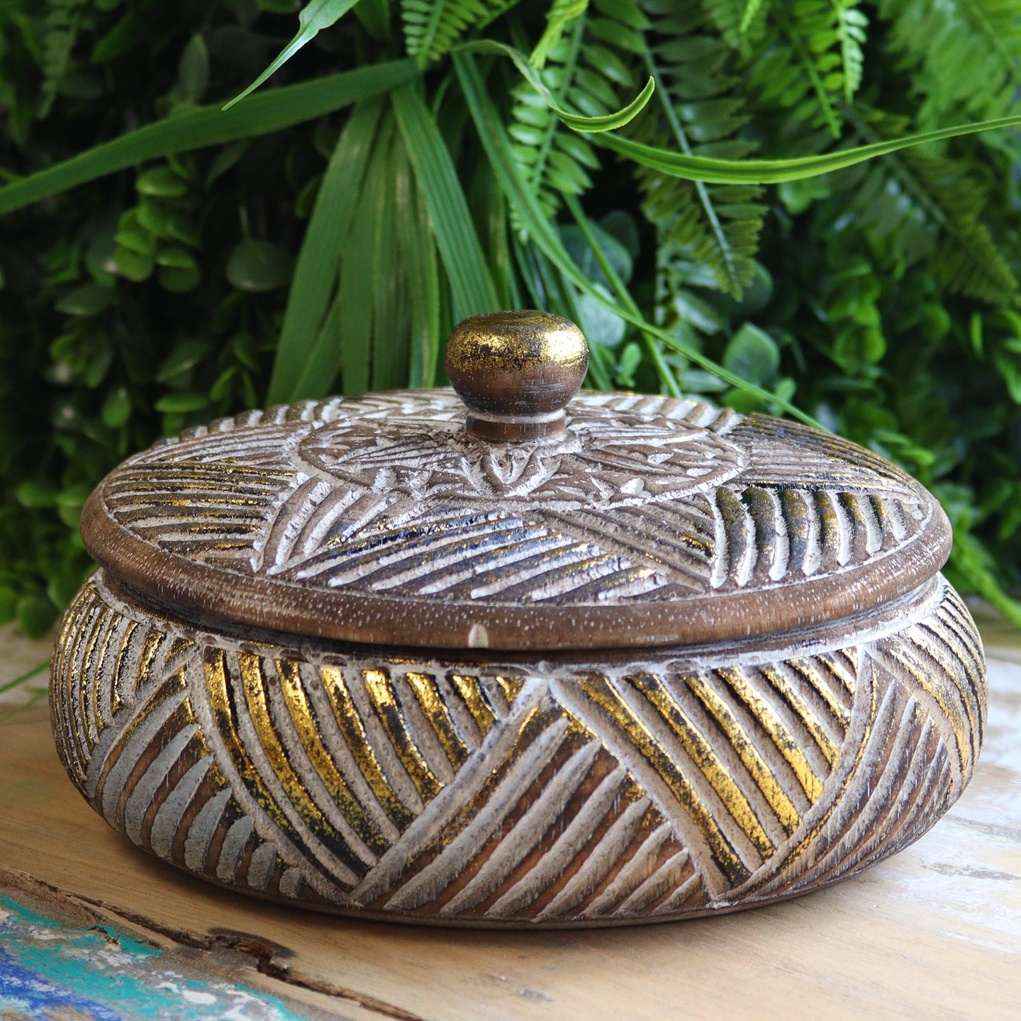 Round wooden gold trinket jewelry box on vanity
