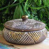Round wooden gold trinket jewelry box on vanity